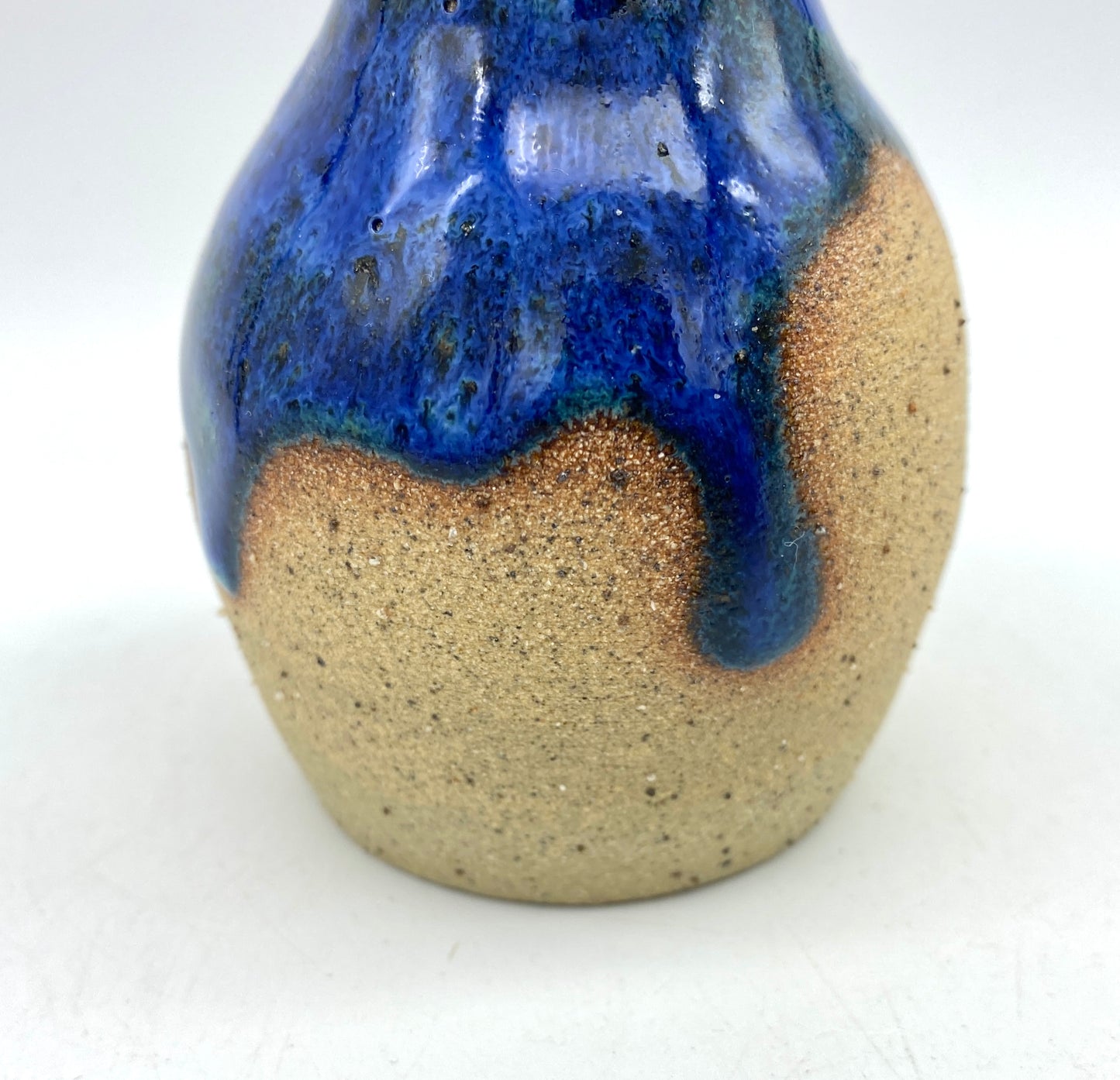 Teeny vase in rich blues and speckled clay