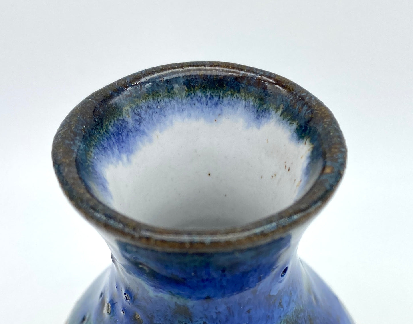 Teeny vase in rich blues and speckled clay