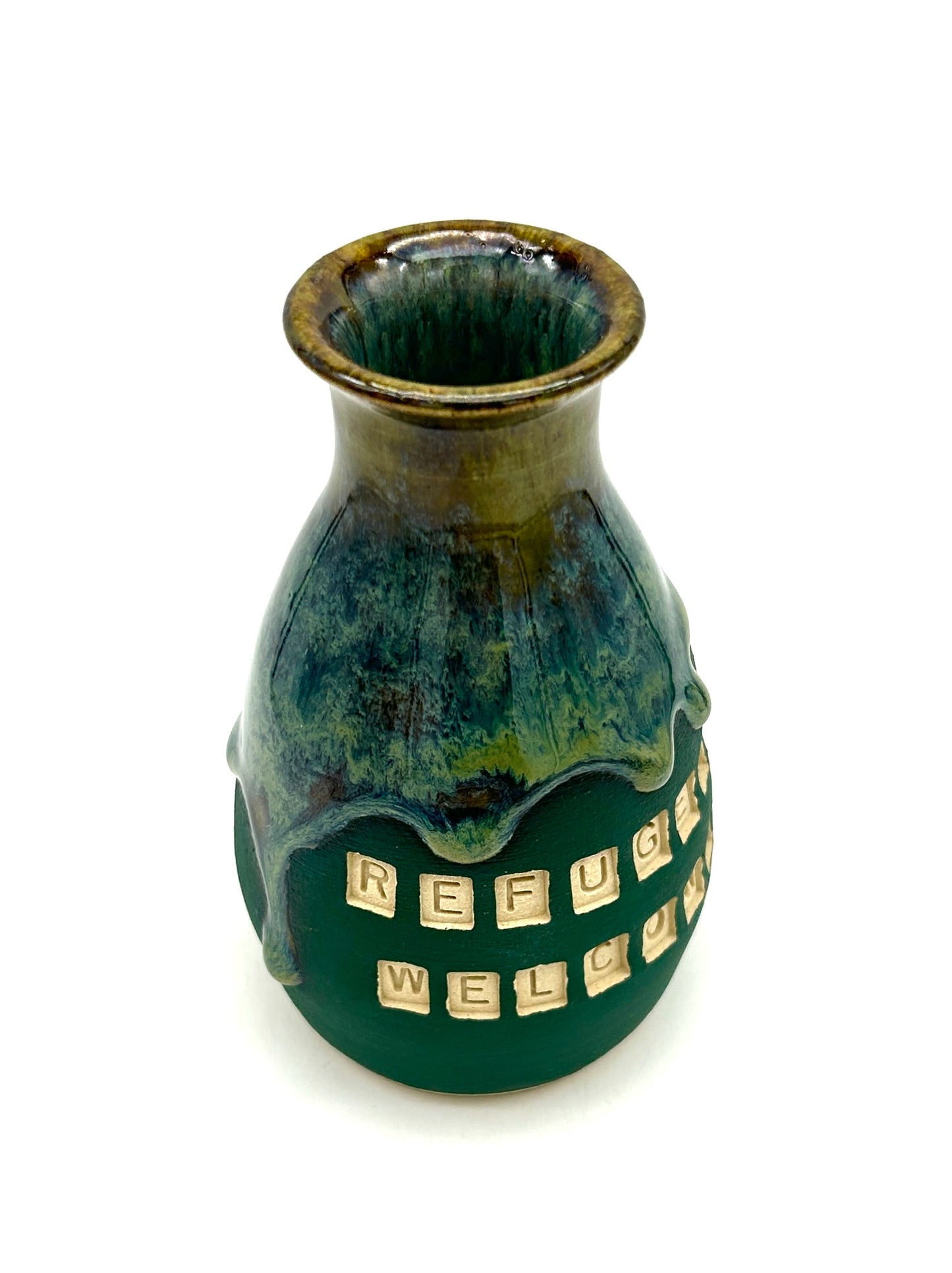 'Refugees welcome' vase in rich green flowing glazes