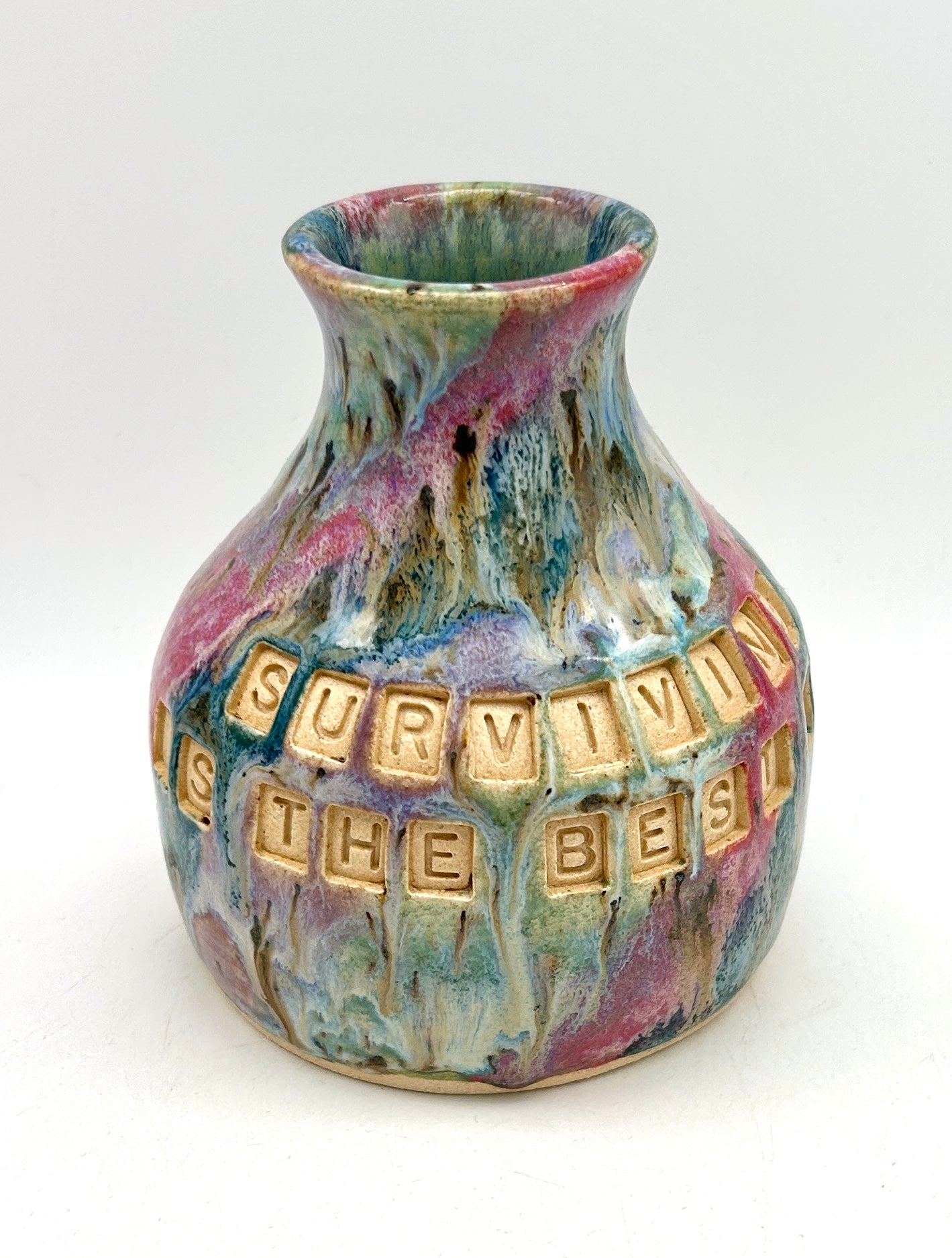 'Surviving is the best revenge' bud vase in my 'aurora' glaze combination