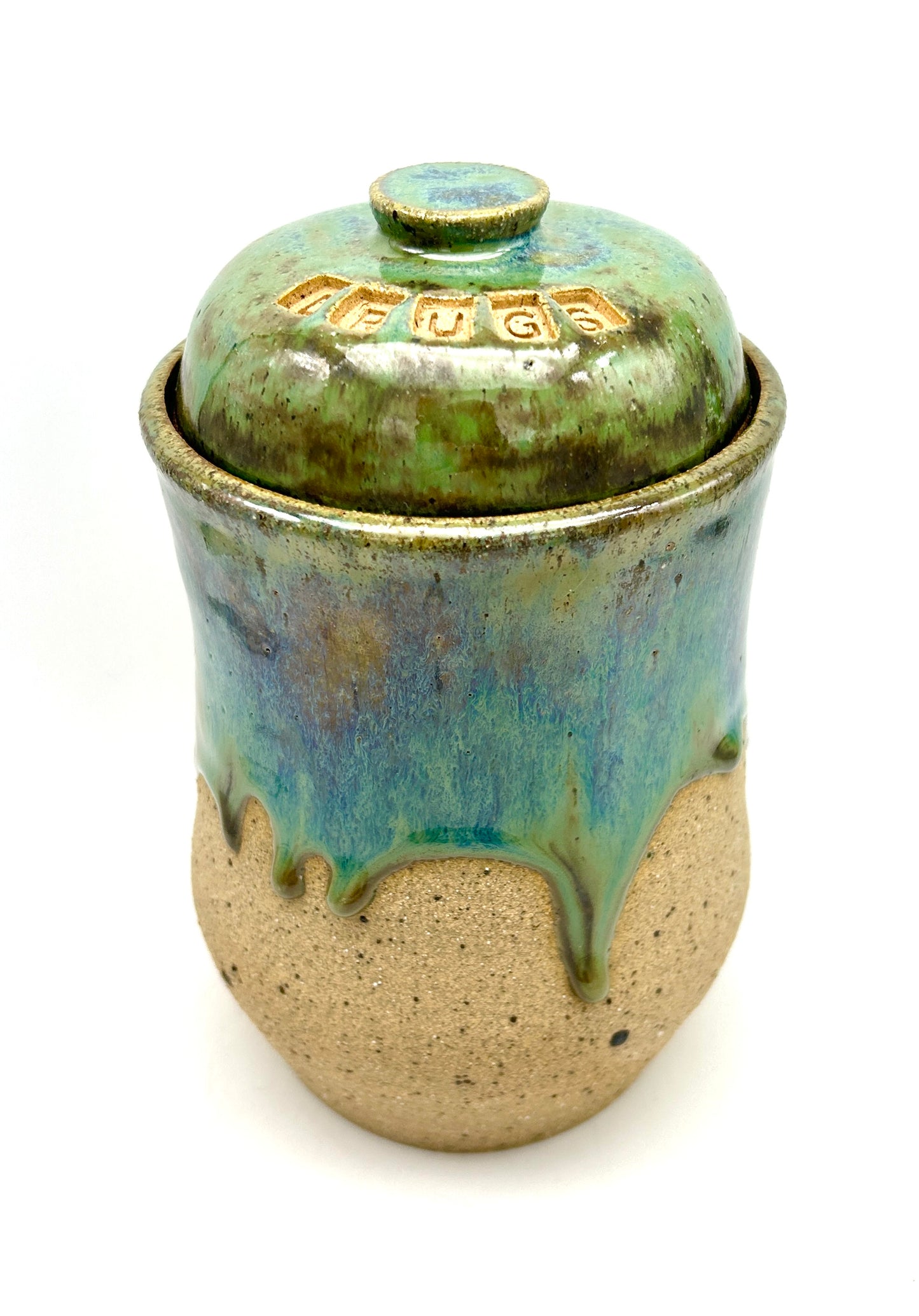 Tall 'drugs' jar in toasty clay glazed in flowing greens