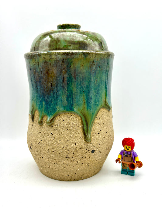 Tall 'drugs' jar in toasty clay glazed in flowing greens