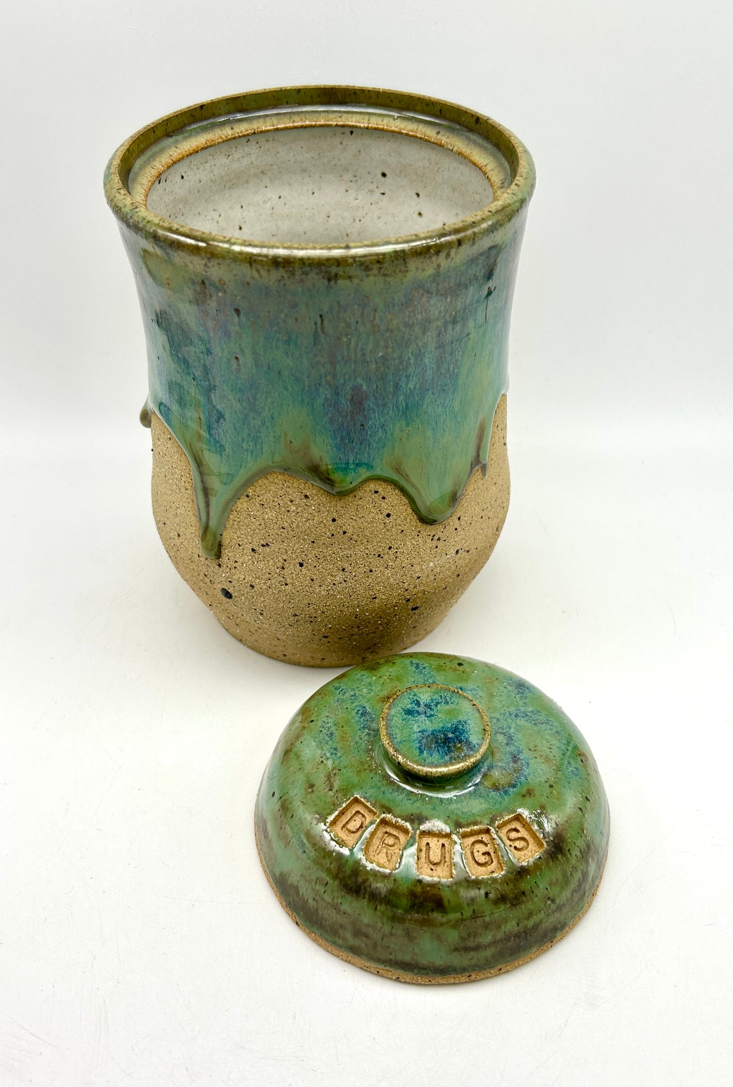 Tall 'drugs' jar in toasty clay glazed in flowing greens