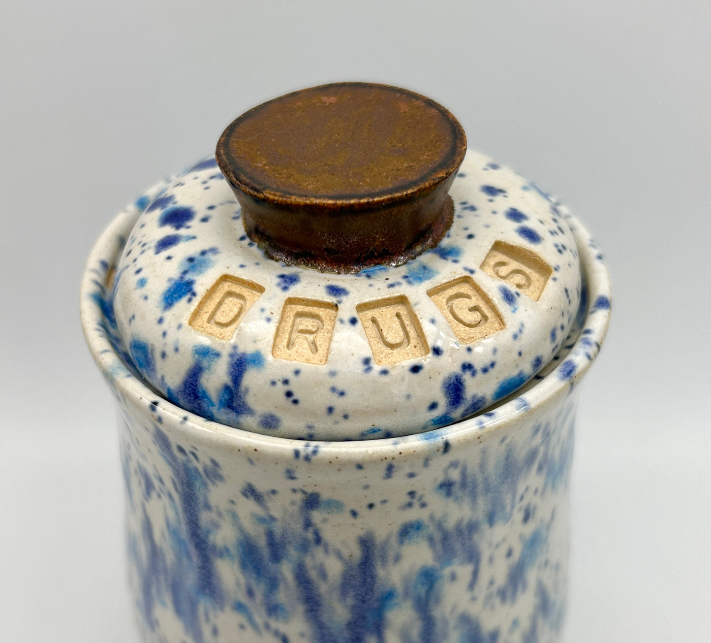 Small 'drugs' lidded jar in speckled blues