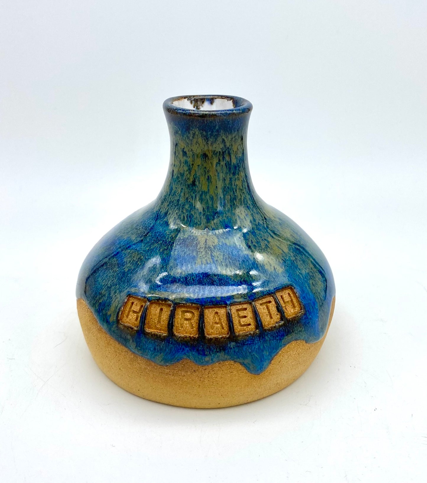 'Hiraeth' bud vase in rich blue glazes on toasty clay