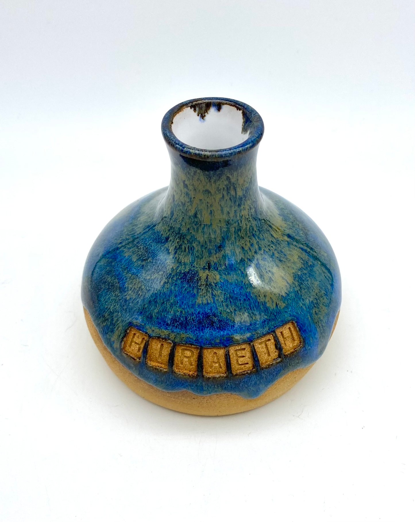 'Hiraeth' bud vase in rich blue glazes on toasty clay