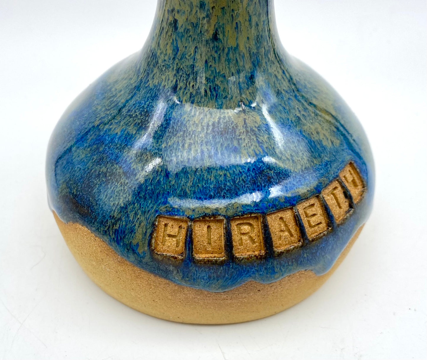 'Hiraeth' bud vase in rich blue glazes on toasty clay