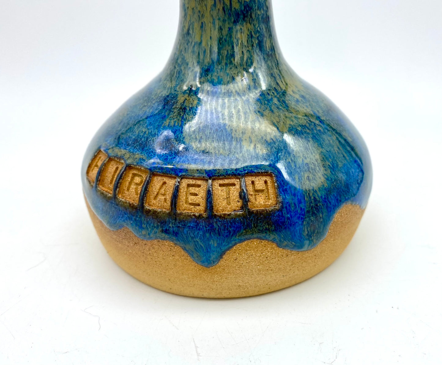 'Hiraeth' bud vase in rich blue glazes on toasty clay