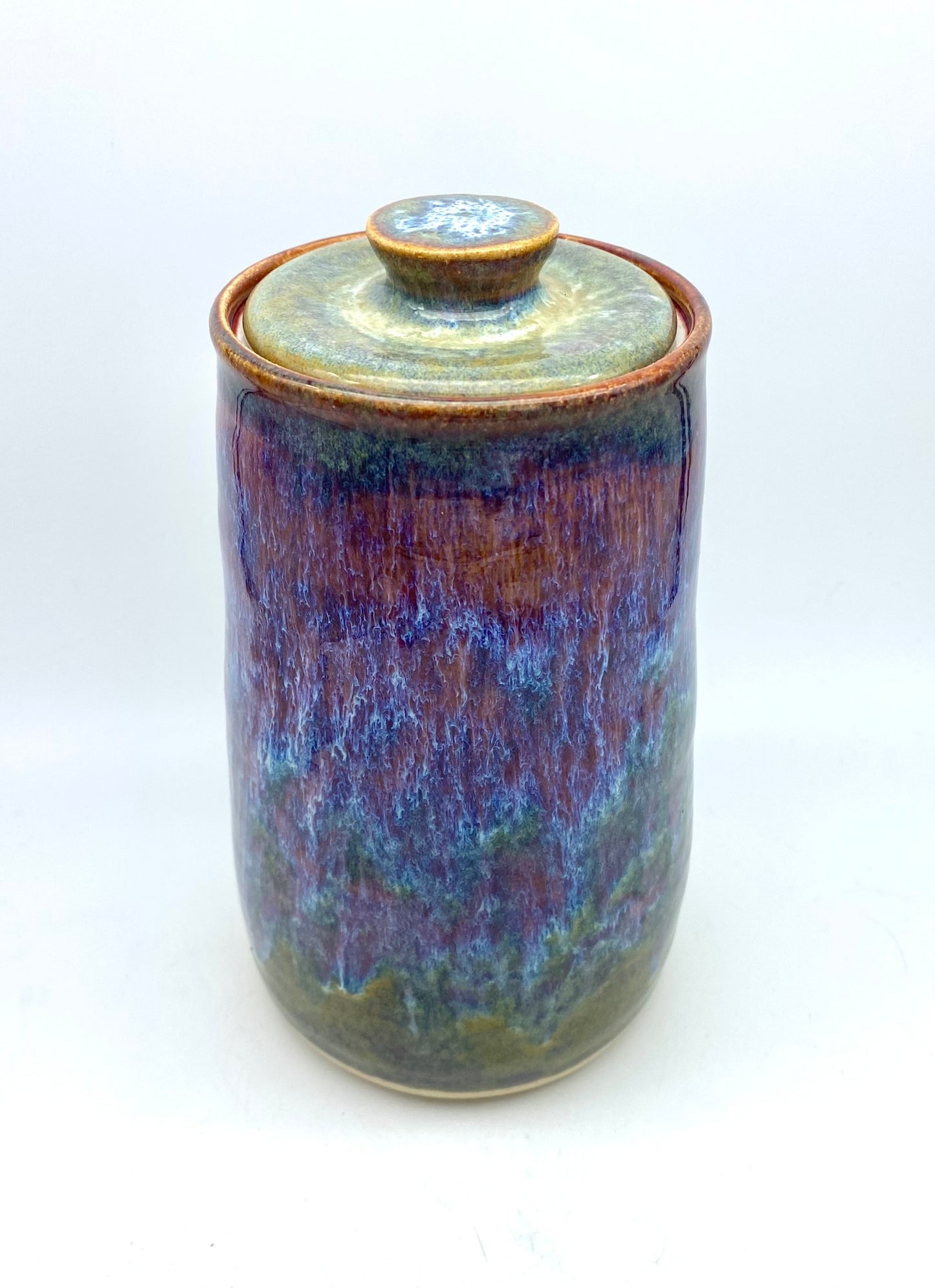 Tall lidded jar in heathery glazes