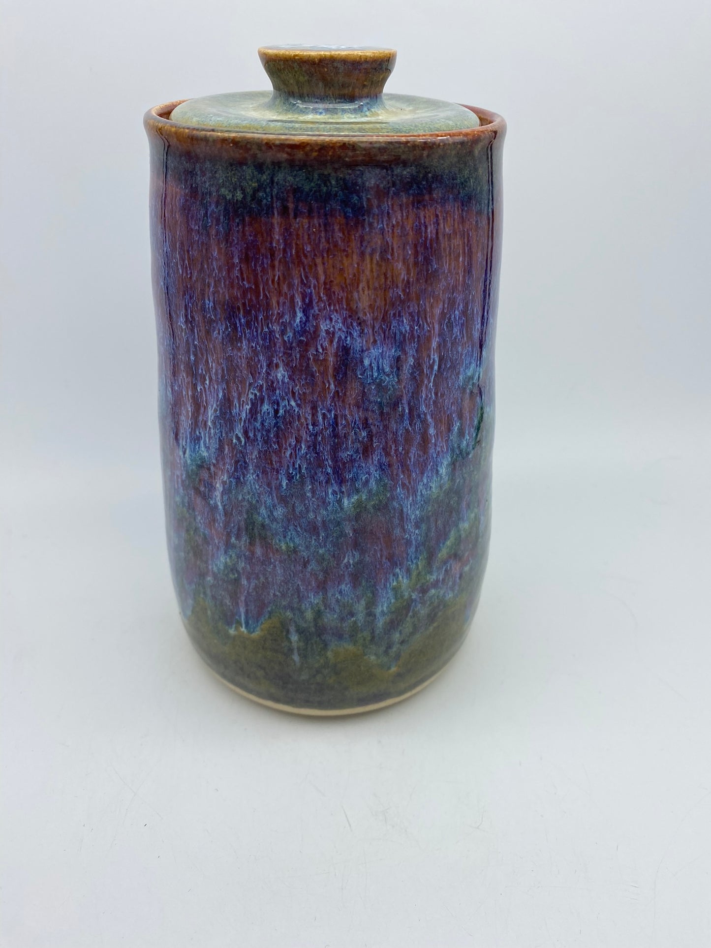 Tall lidded jar in heathery glazes