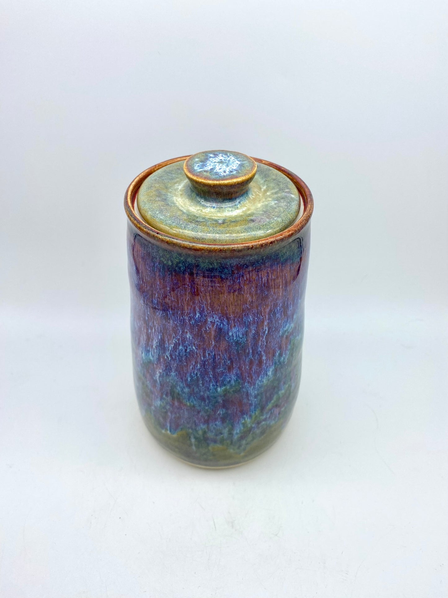 Tall lidded jar in heathery glazes