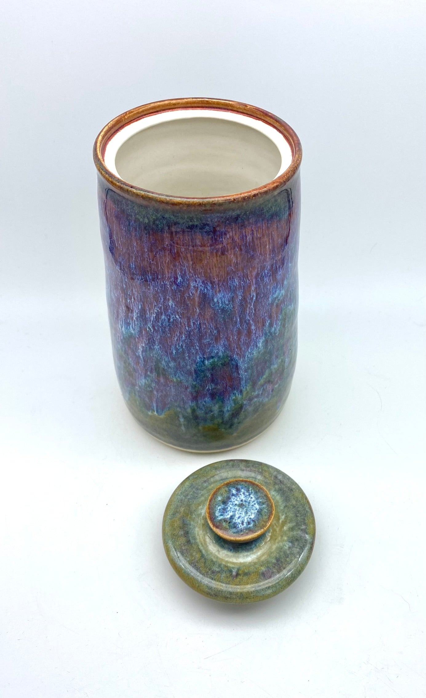 Tall lidded jar in heathery glazes