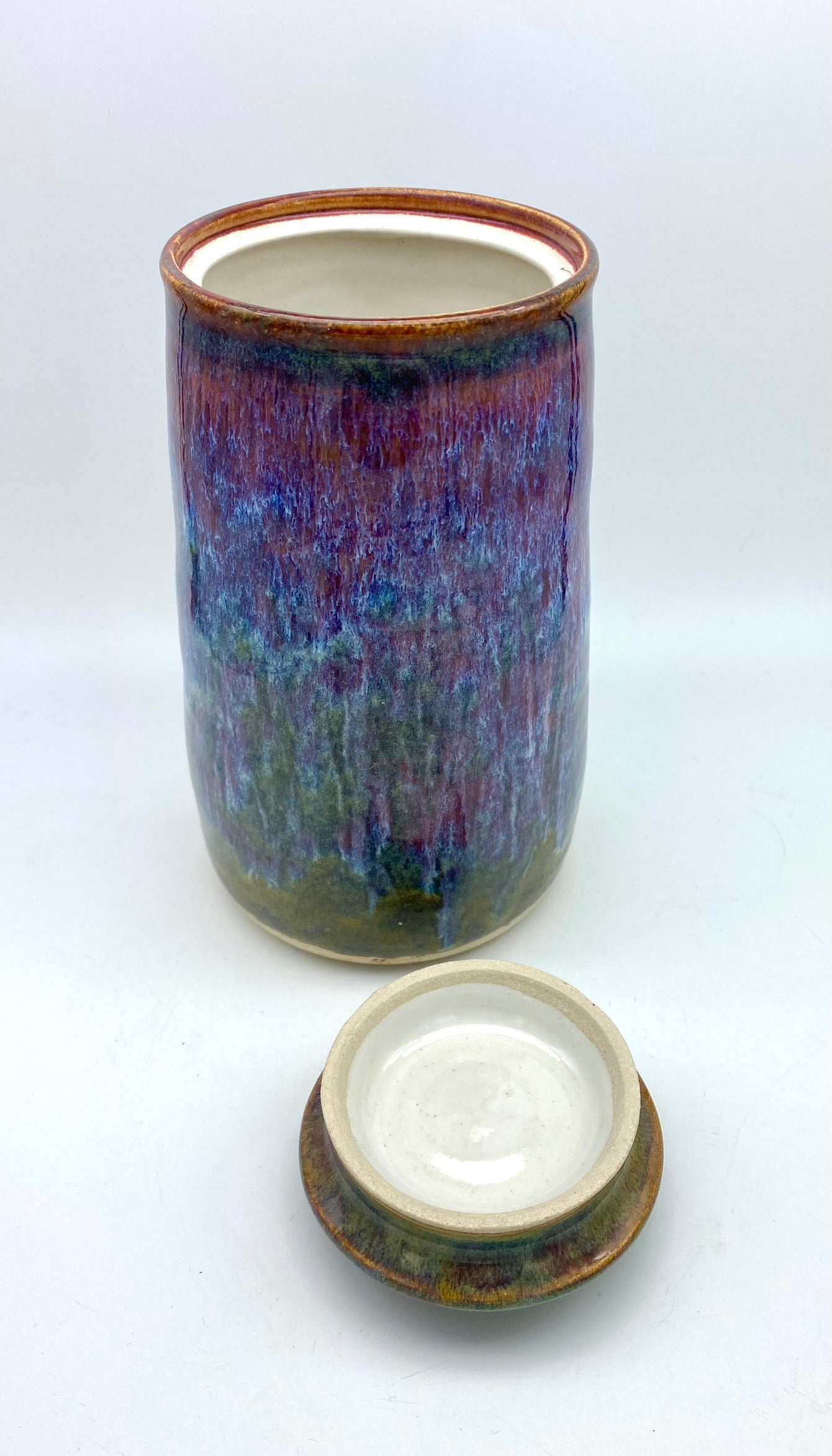 Tall lidded jar in heathery glazes