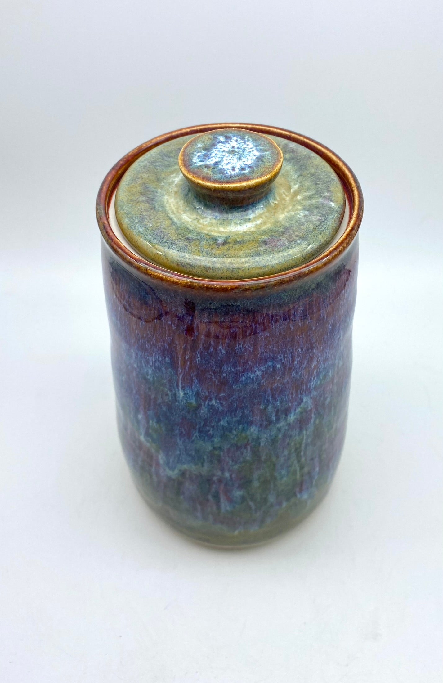 Tall lidded jar in heathery glazes