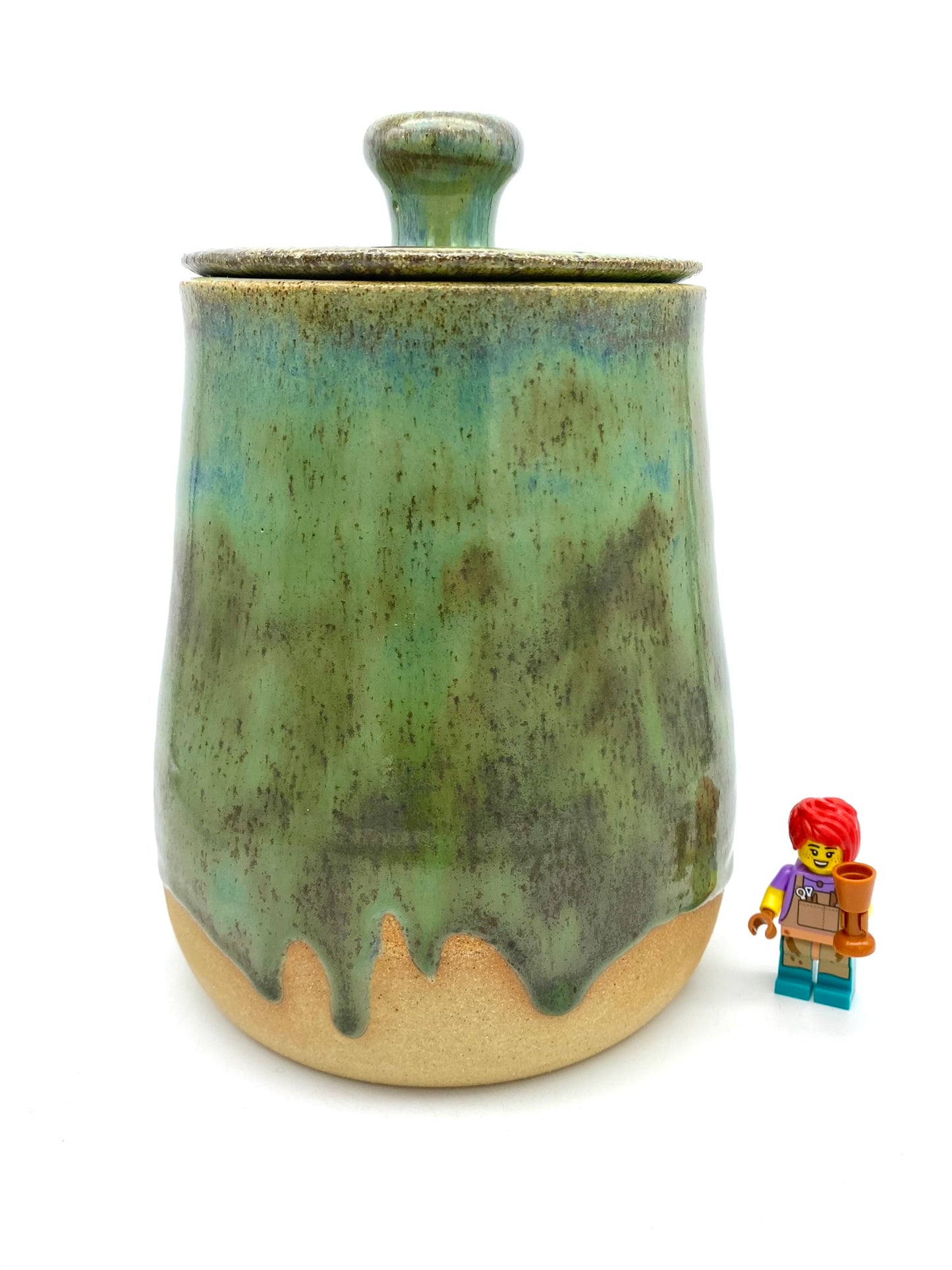 Lidded jar in greens on speckled clay