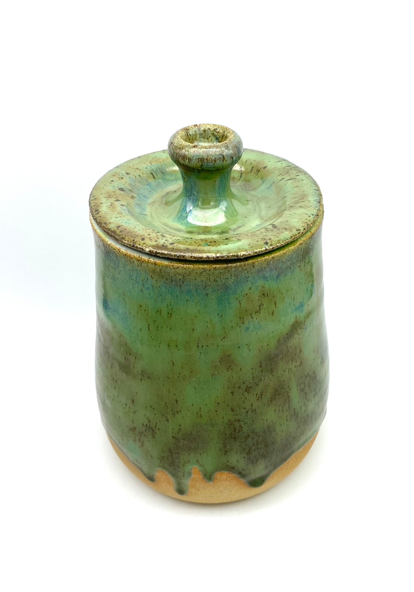 Lidded jar in greens on speckled clay