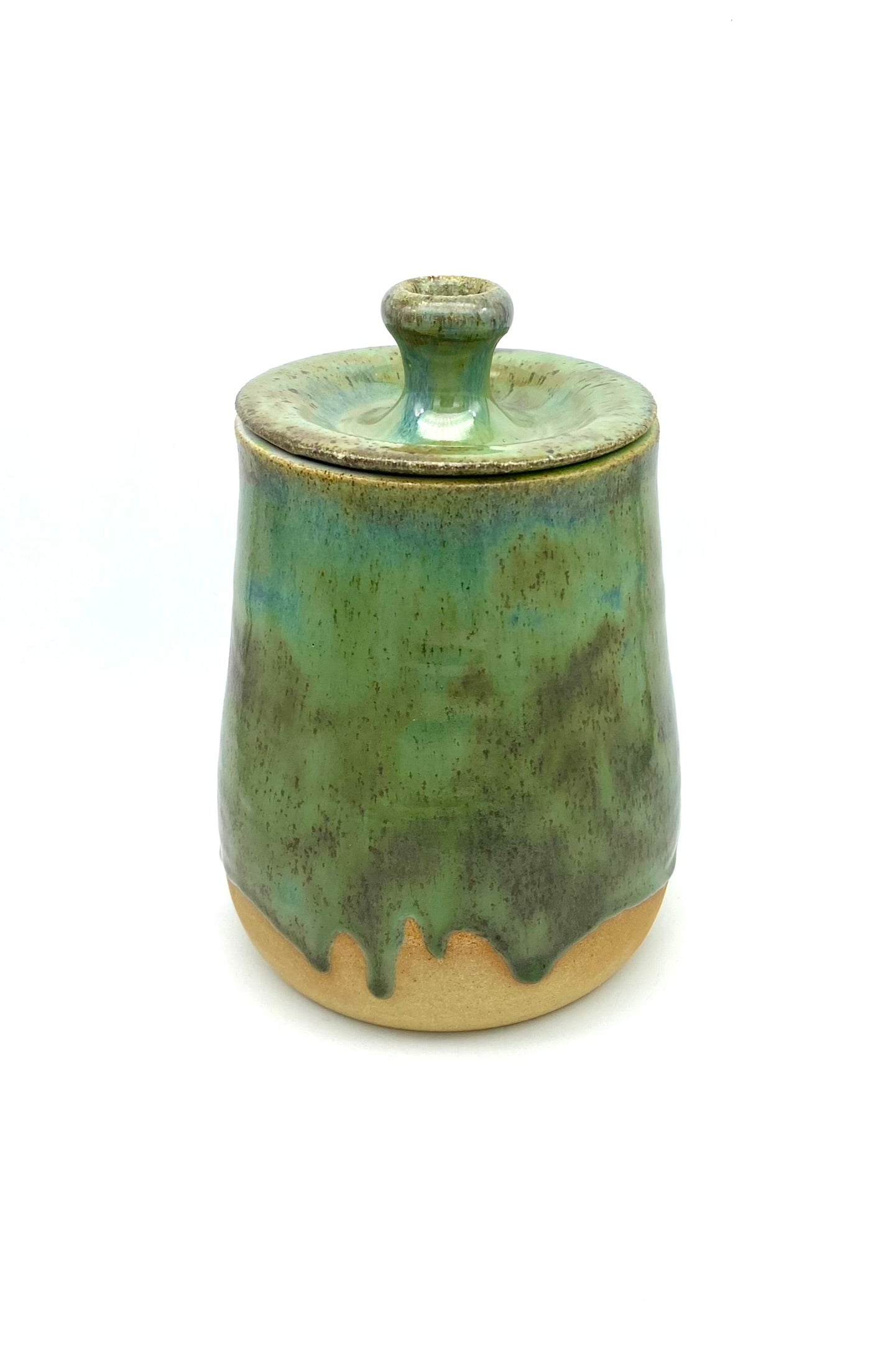 Lidded jar in greens on speckled clay