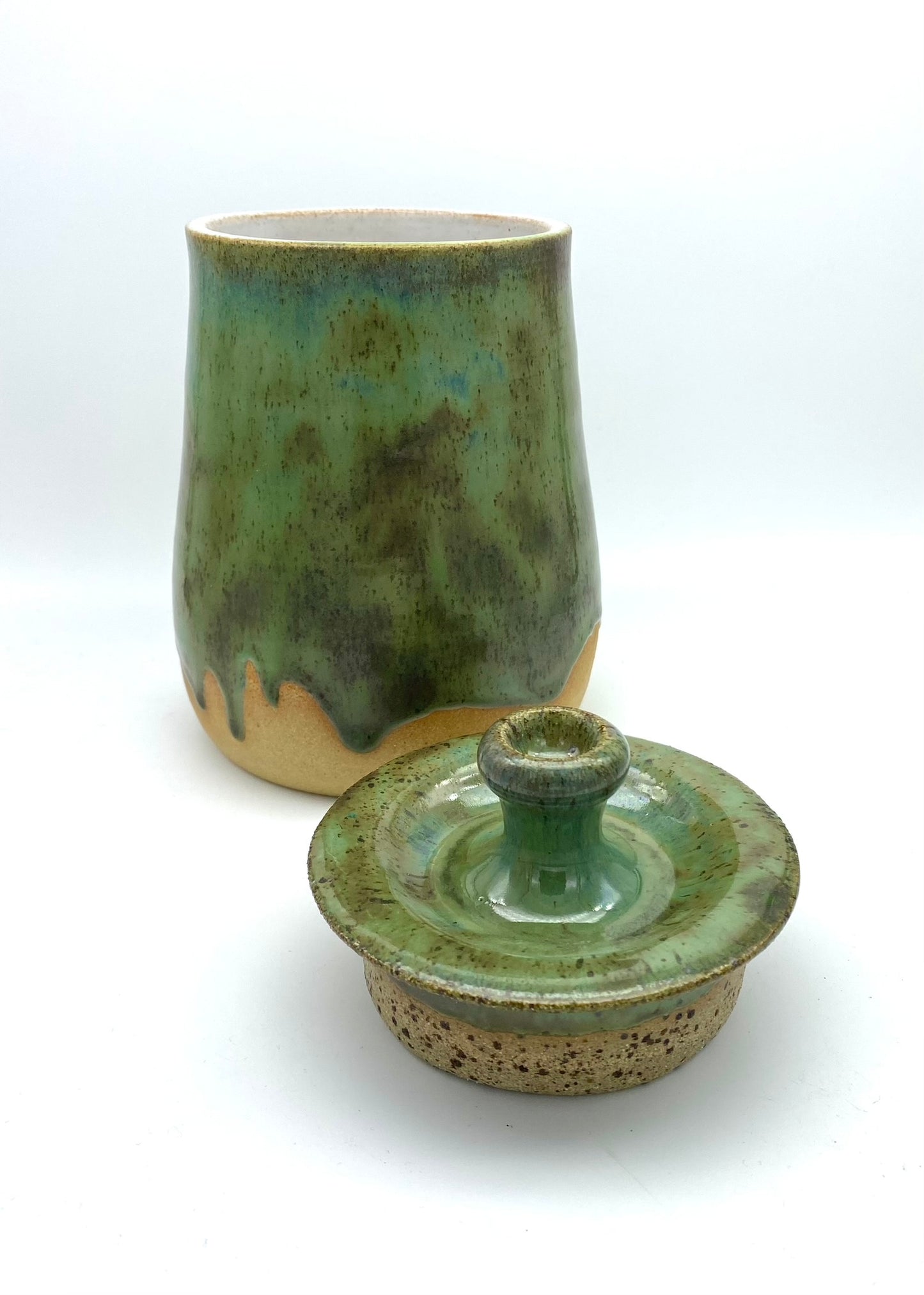 Lidded jar in greens on speckled clay