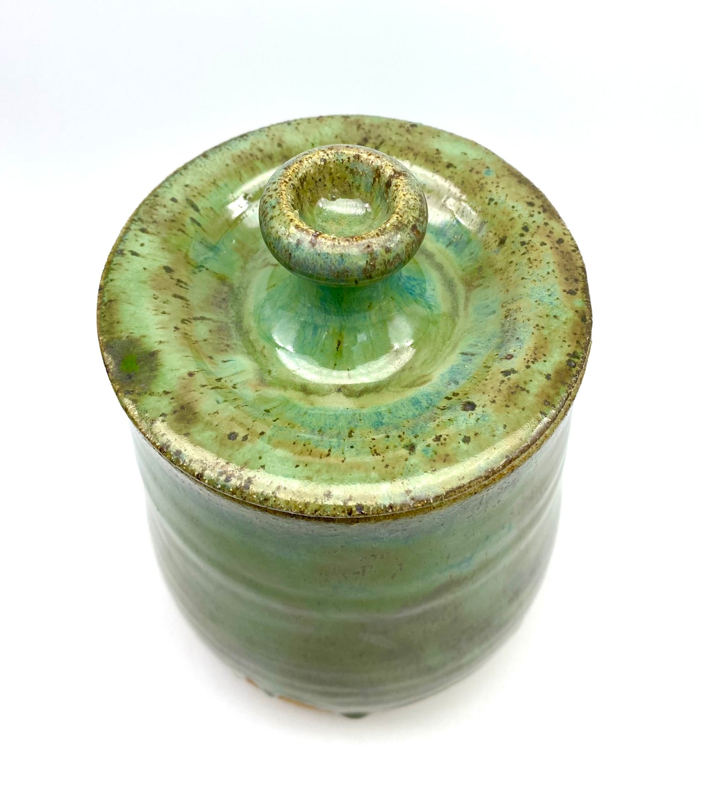 Lidded jar in greens on speckled clay