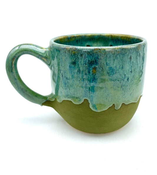 Mug in lush dripping greens