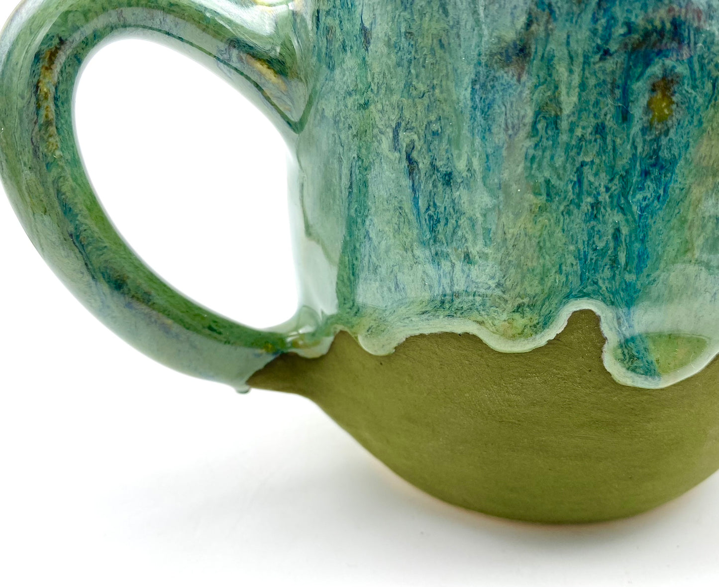 Mug in lush dripping greens