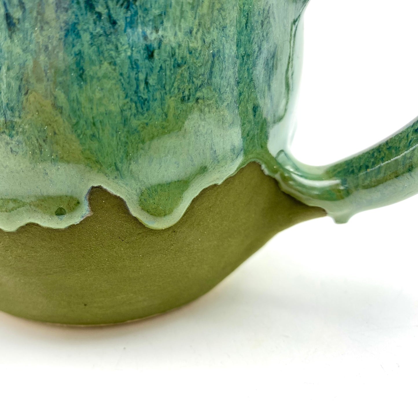 Mug in lush dripping greens