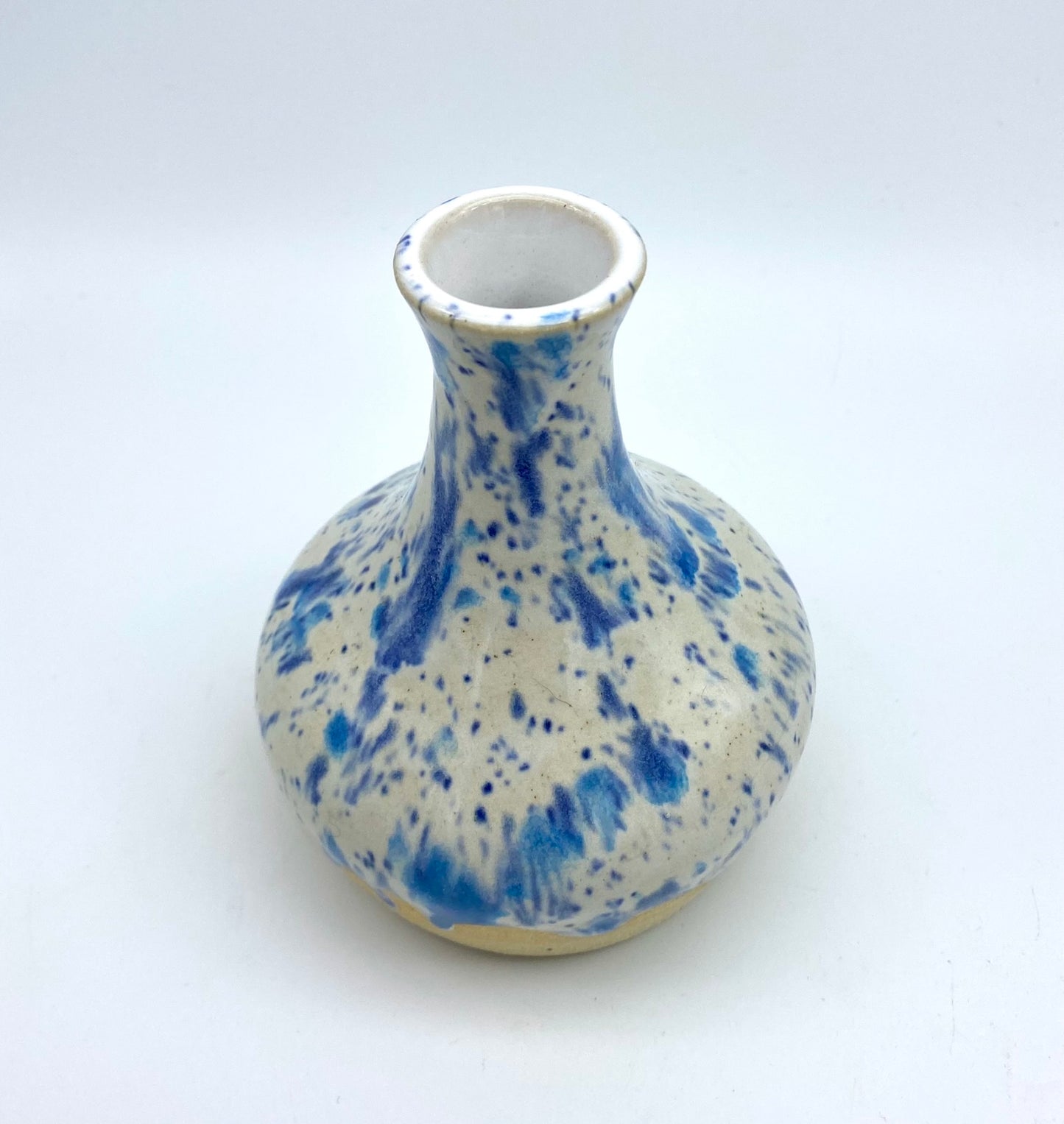 Bud vase in speckled blues on white